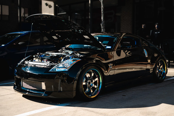 Black Nissan 370Z with the hood up
