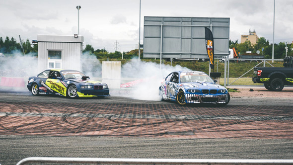 customized racing vehicles drifting on a track